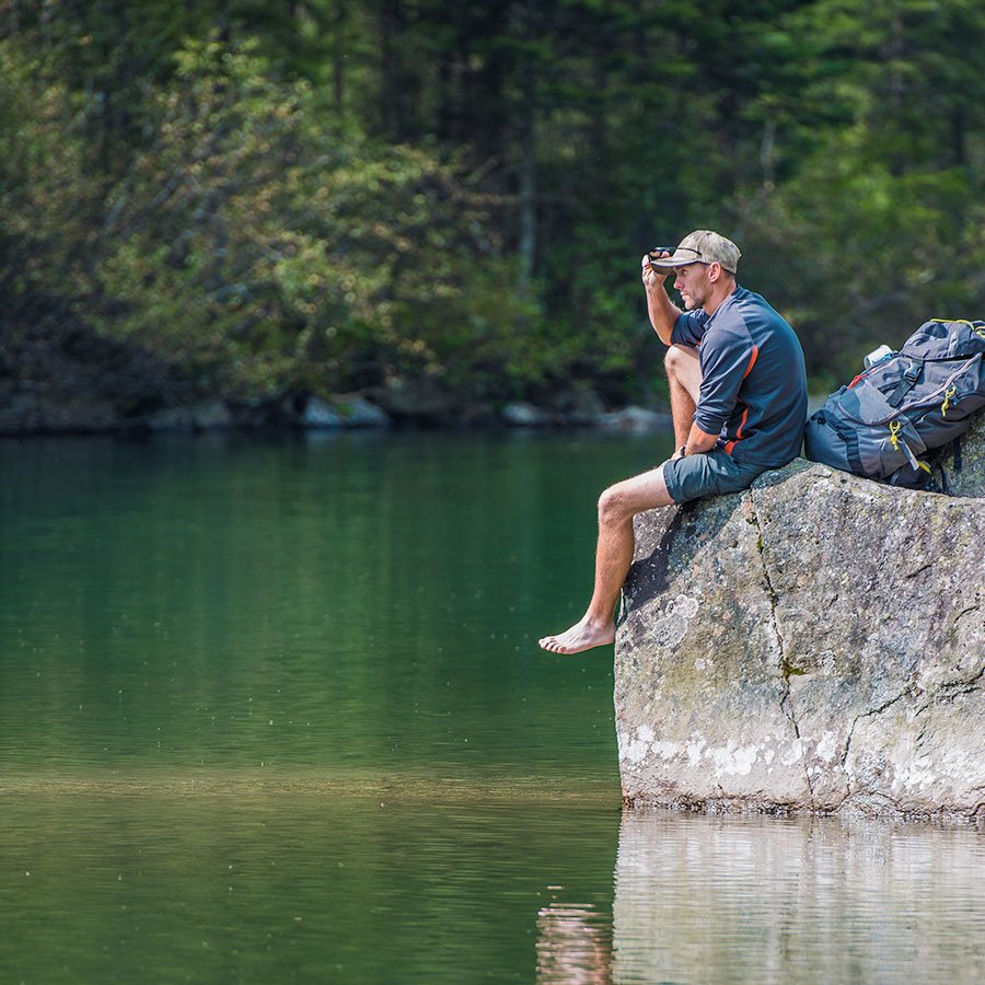 A man enjoys a mountain lake